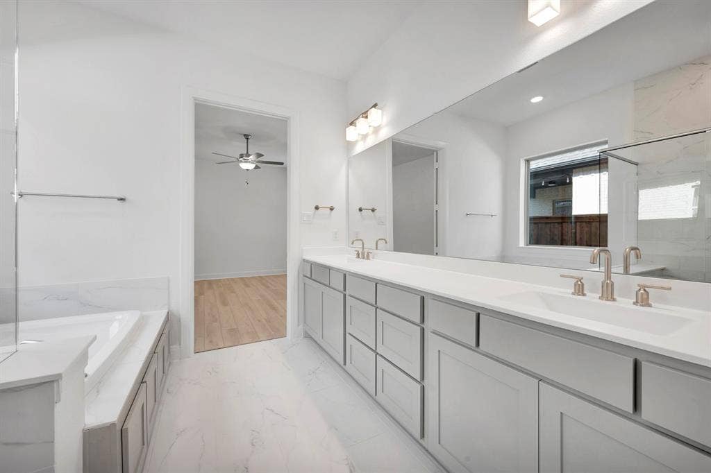 2079 Emerald Grove Lane, Arlington, TX 76005 Full bathroom with double vanity, a garden tub, a marble finish shower, and light marble finish flooring