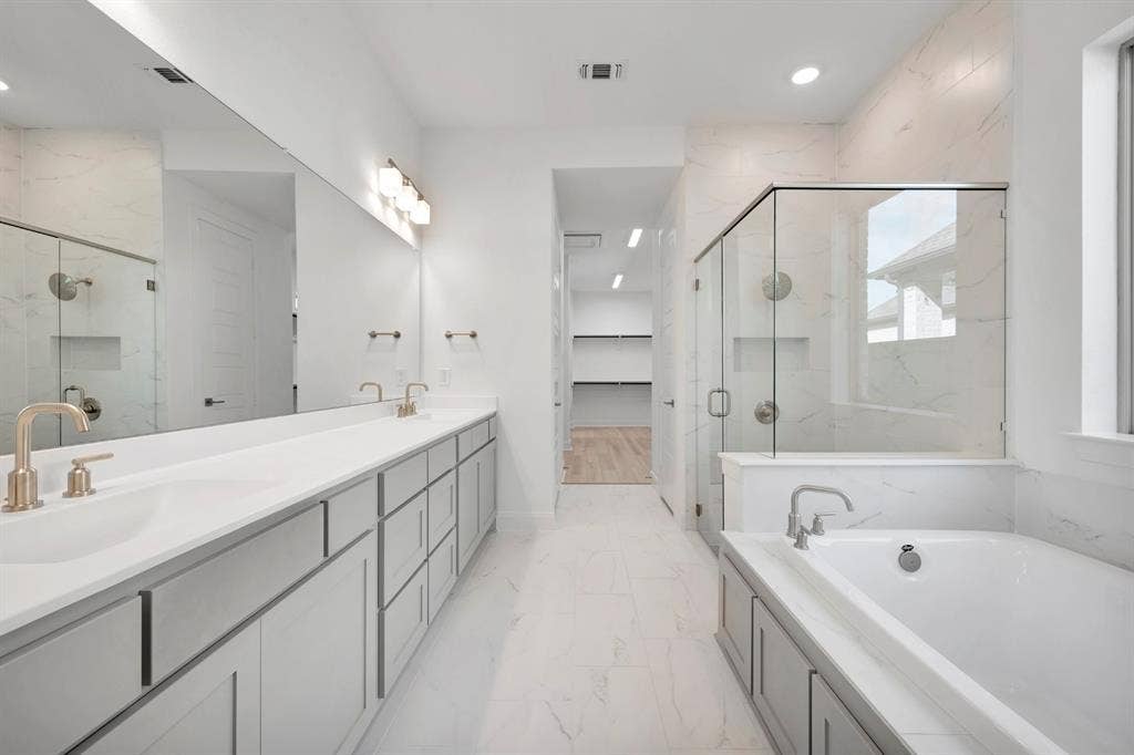 2079 Emerald Grove Lane, Arlington, TX 76005 Full bathroom featuring a marble finish shower, double vanity, a garden tub, light marble finish floors, and recessed lighting