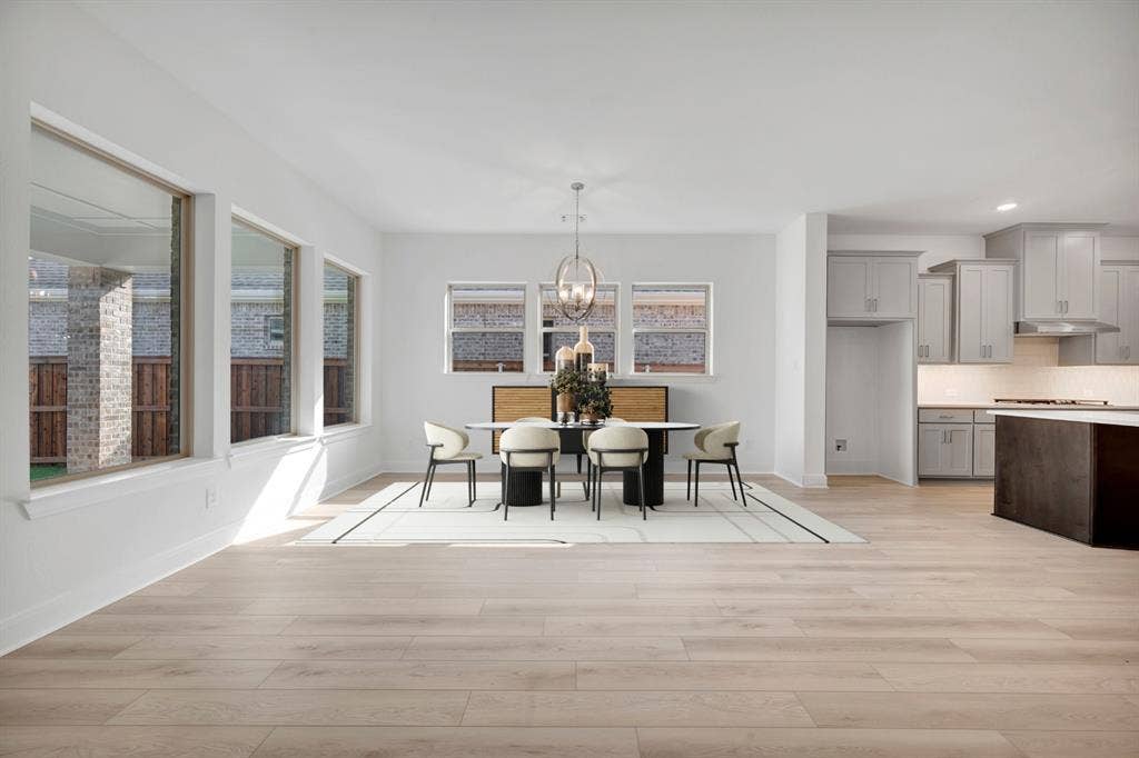 2079 Emerald Grove Lane, Arlington, TX 76005 Dining room featuring light wood-type flooring and hanging lights