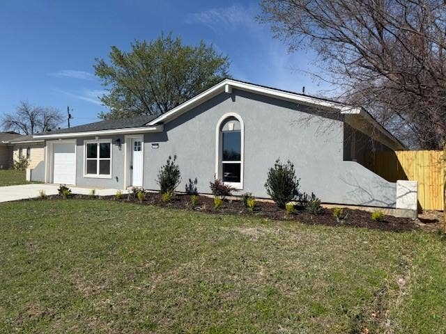 5845 Haney Drive, Watauga, TX 76148 Ranch-style home featuring stucco siding, a garage, and driveway