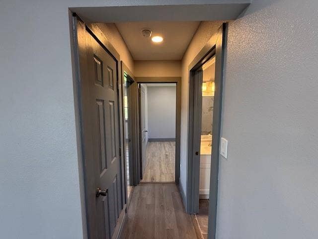 5845 Haney Drive, Watauga, TX 76148 Corridor featuring a textured wall and dark wood-type flooring