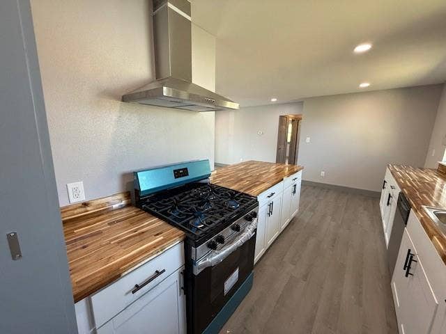 5845 Haney Drive, Watauga, TX 76148 Kitchen featuring wooden counters, stainless steel appliances, dark wood-style floors, recessed lighting, and white cabinets
