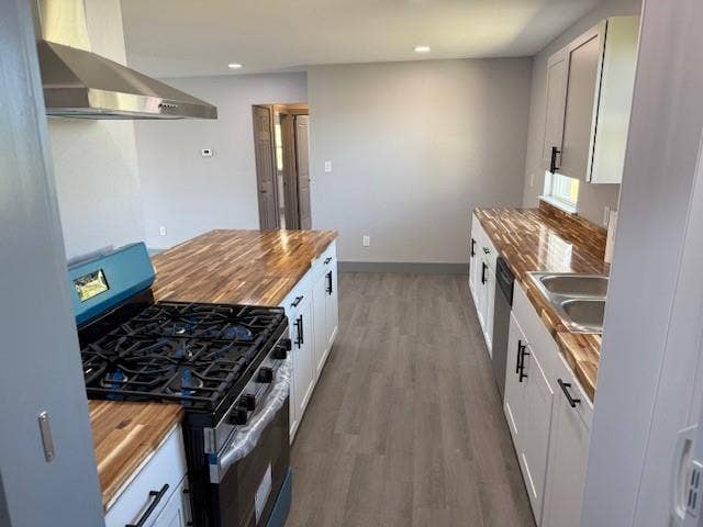5845 Haney Drive, Watauga, TX 76148 Kitchen featuring wooden counters, stainless steel appliances, dark wood-style floors, recessed lighting, and white cabinetry