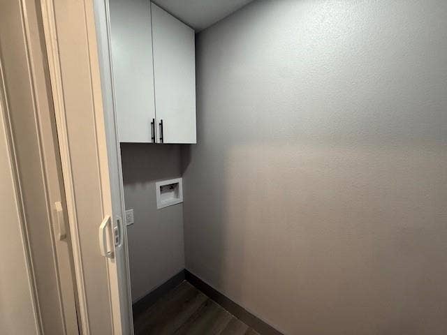 5845 Haney Drive, Watauga, TX 76148 Laundry room with hookup for a washing machine, dark wood-style flooring, and cabinet space