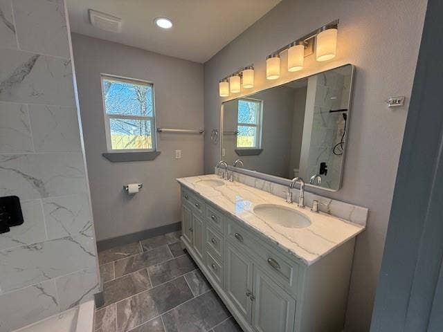 5845 Haney Drive, Watauga, TX 76148 Full bathroom with double vanity, tiled shower, and stone finish flooring