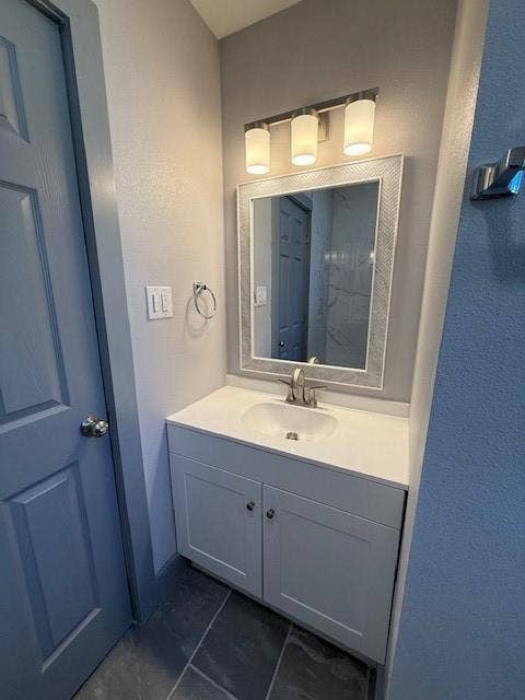 5845 Haney Drive, Watauga, TX 76148 Bathroom featuring vanity and a textured wall