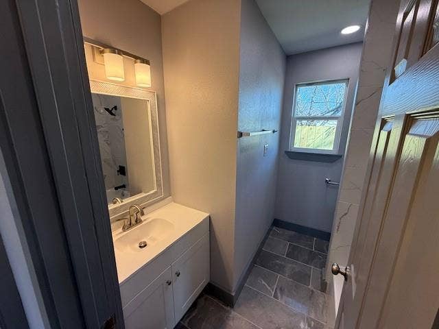 5845 Haney Drive, Watauga, TX 76148 Full bath featuring vanity, a textured wall, and a shower