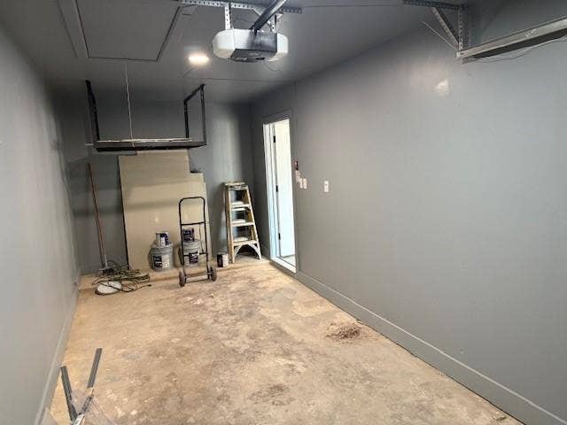 5845 Haney Drive, Watauga, TX 76148 Garage featuring baseboards and a garage door opener