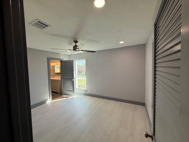 5845 Haney Drive, Watauga, TX 76148 Unfurnished bedroom featuring light wood-style flooring, connected bathroom, ceiling fan, and recessed lighting