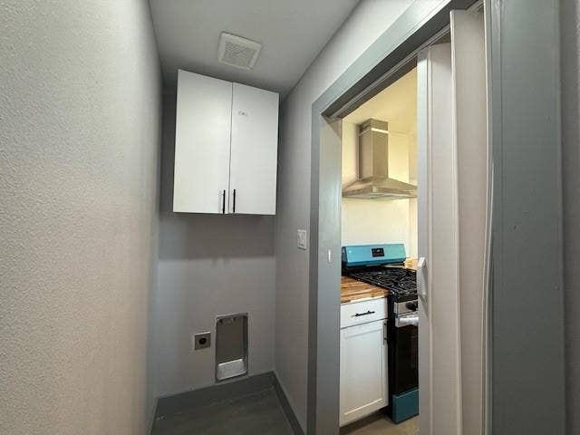 5845 Haney Drive, Watauga, TX 76148 Laundry area featuring hookup for an electric dryer and cabinet space