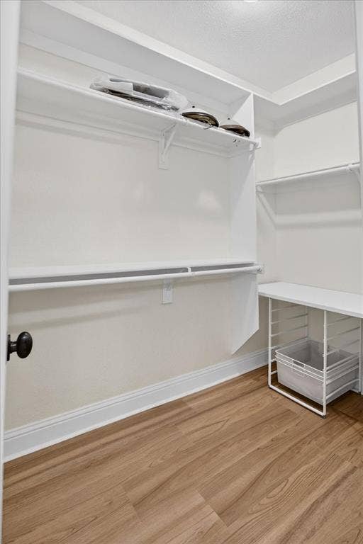 5182 Bayshore Drive, Athens, TX 75752 Walk in closet with light wood finished floors