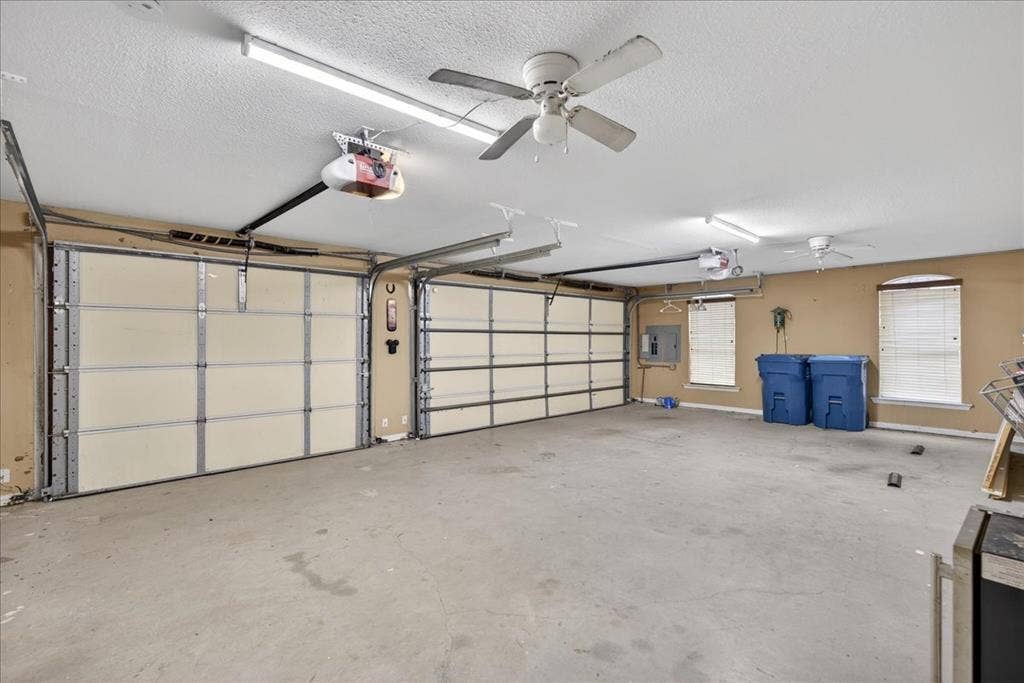 5182 Bayshore Drive, Athens, TX 75752 Garage with ceiling fan, a garage door opener, and electric panel