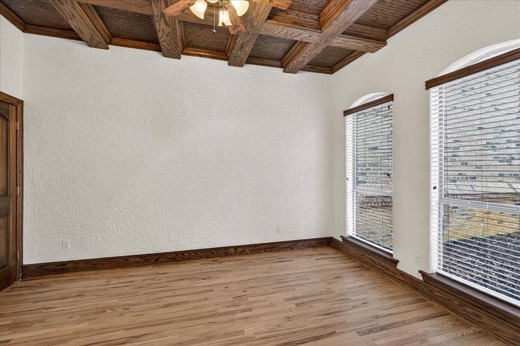 5182 Bayshore Drive, Athens, TX 75752 Empty room with wooden ceiling, a ceiling fan, coffered ceiling, wood finished floors, and a textured wall