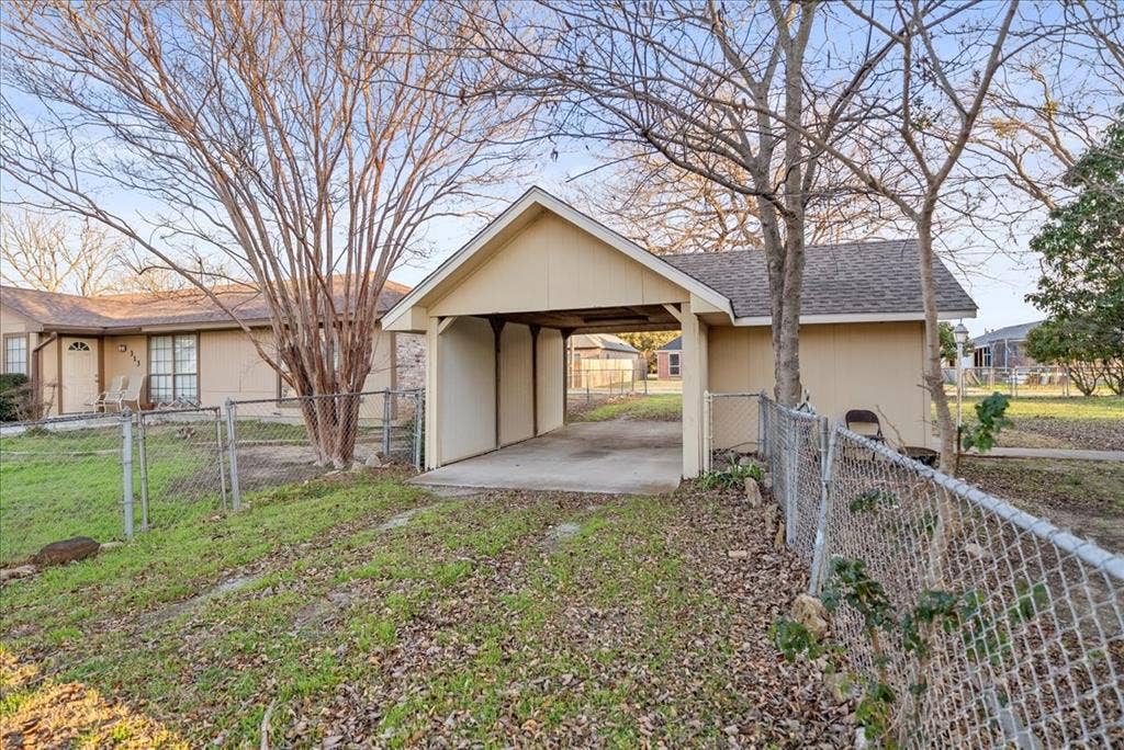 101 N 7th Street, Krum, TX 76249 View of outbuilding with a gate