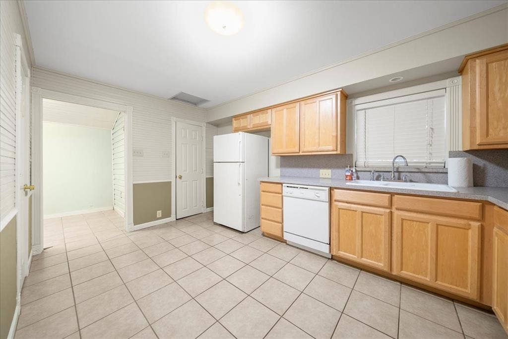 101 N 7th Street, Krum, TX 76249 Kitchen with light brown cabinets, white appliances, light countertops, and light tile patterned floors