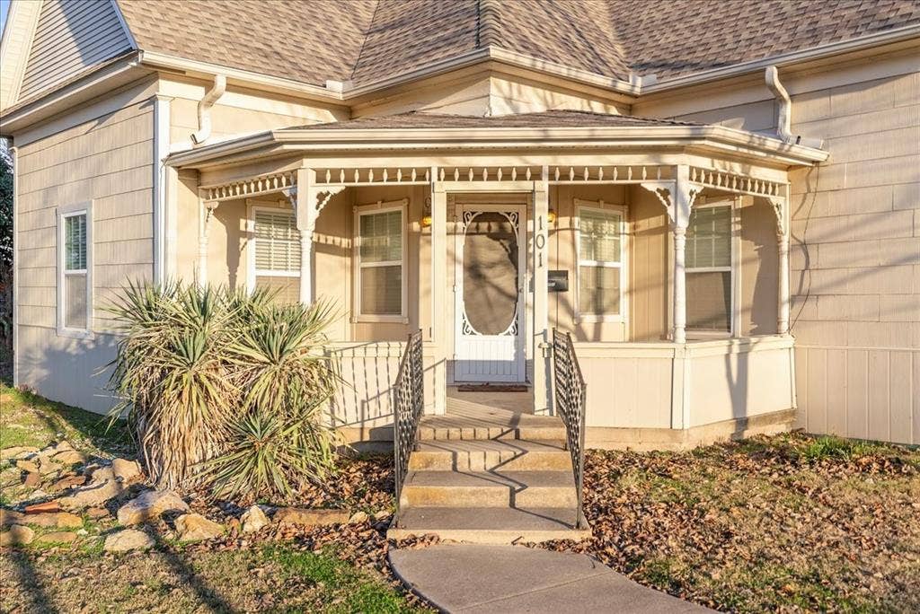 101 N 7th Street, Krum, TX 76249 Property entrance featuring roof with shingles and covered porch