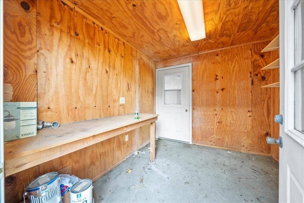 101 N 7th Street, Krum, TX 76249 Misc room with wood walls, unfinished concrete flooring, and wood ceiling