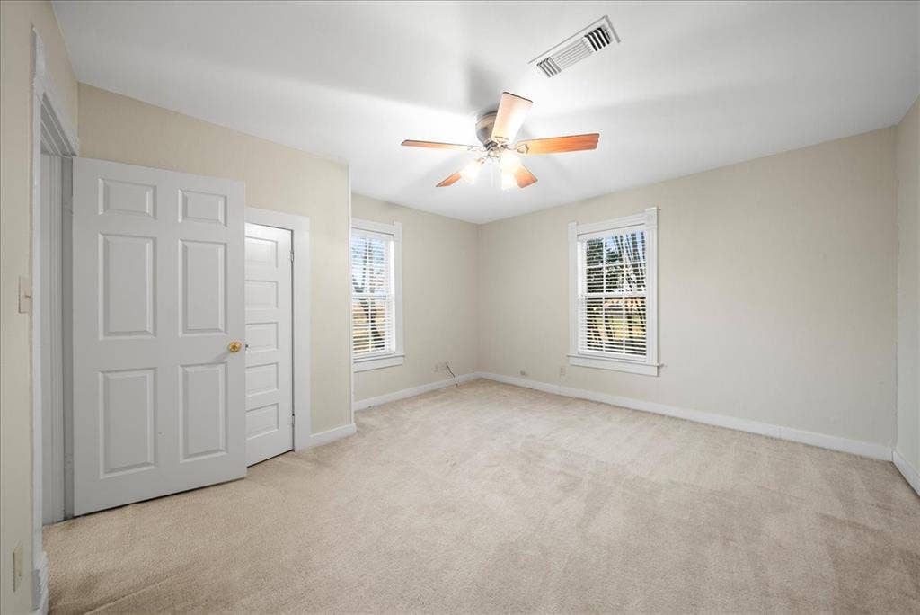 101 N 7th Street, Krum, TX 76249 Unfurnished bedroom featuring light carpet and a ceiling fan