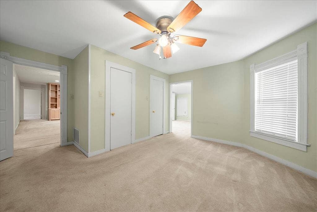 101 N 7th Street, Krum, TX 76249 Unfurnished bedroom with light colored carpet, ceiling fan, and a closet