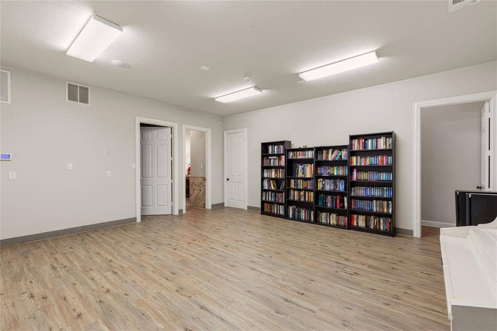 Open-concept living space featuring wood-finish flooring, recessed lighting, and a neutral color palette