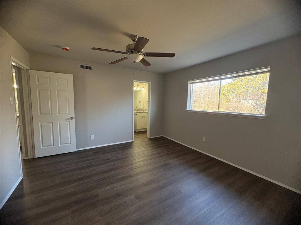 117 Yorkshire Drive, Cedar Hill, TX 75104 Unfurnished master bedroom with dark wood-style floors, ceiling fan, and ensuite bathroom