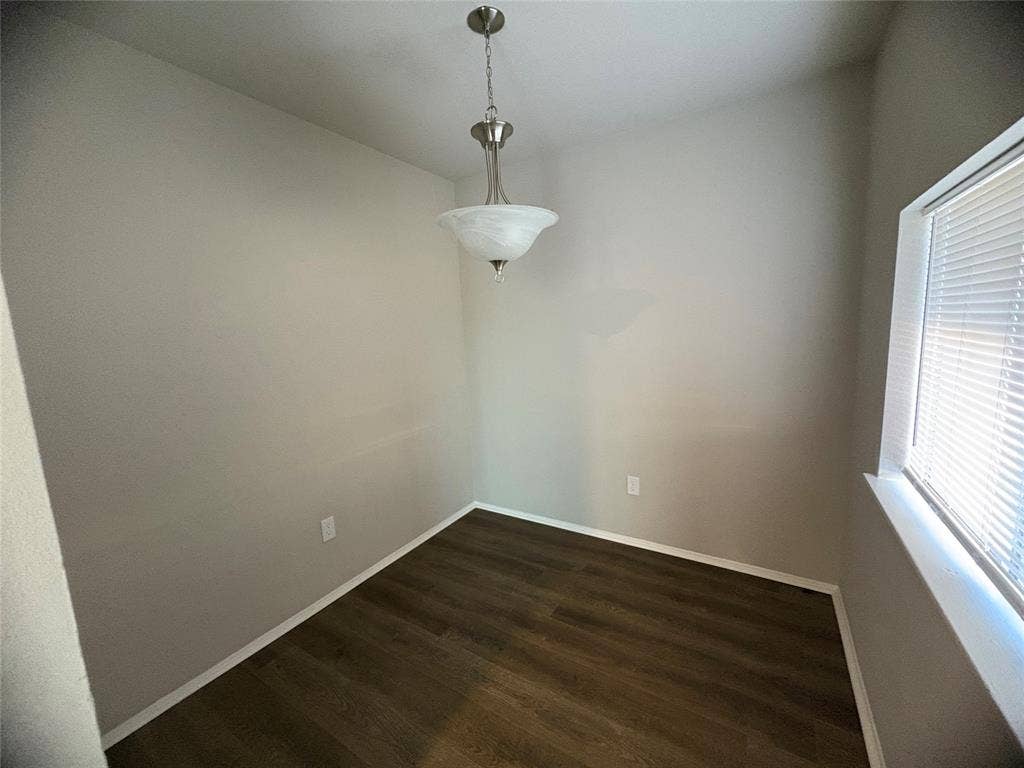 117 Yorkshire Drive, Cedar Hill, TX 75104 Small bonus room off kitchen, could be dining, office space or play room area with dark wood-type flooring and baseboards, window overlooking the backyard
