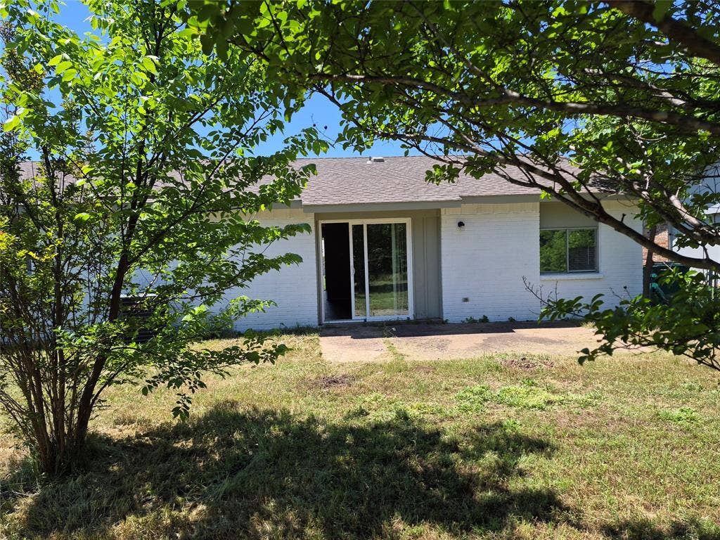 117 Yorkshire Drive, Cedar Hill, TX 75104 Rear exterior with a concrete patio, sliding glass door, and a single window