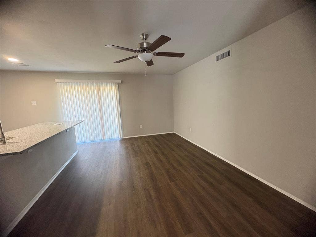 117 Yorkshire Drive, Cedar Hill, TX 75104 Unfurnished living room with dark wood-type flooring and ceiling fan