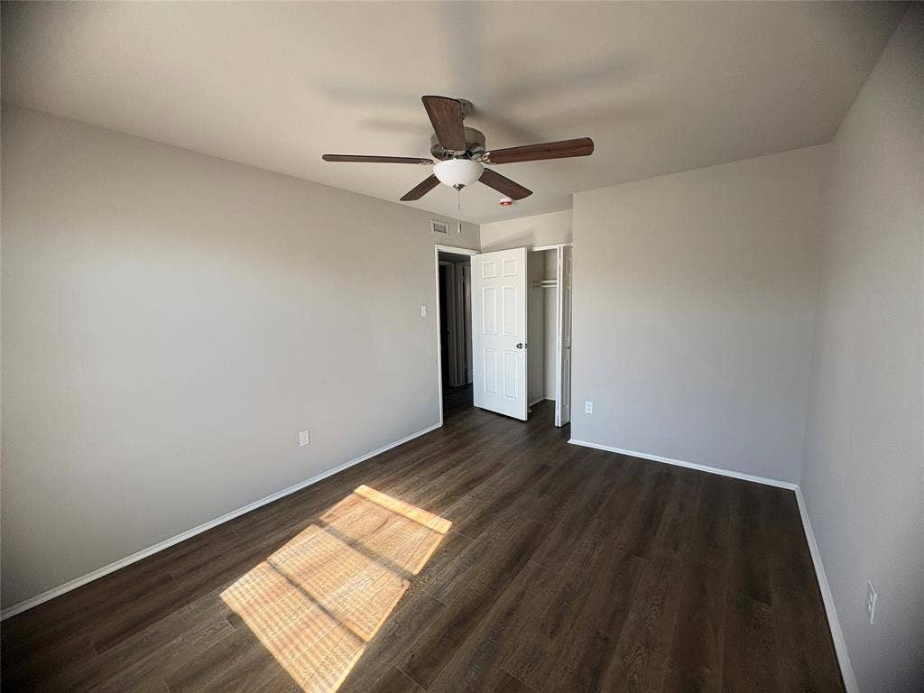 117 Yorkshire Drive, Cedar Hill, TX 75104 Unfurnished bedroom 2 featuring a closet, ceiling fan, and dark wood finished floors