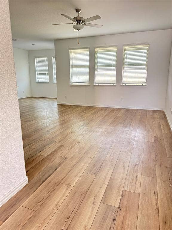 8309 Caracara Court, McKinney, TX 75071 Unfurnished room with a ceiling fan and light wood-type flooring