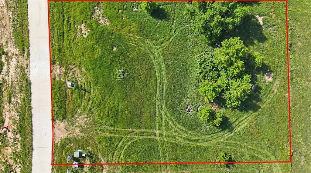 This is an aerial photograph of Lot 2 Block G and was captured in February. It has been digitally enhanced to emphasize the presence of leaves and grass.