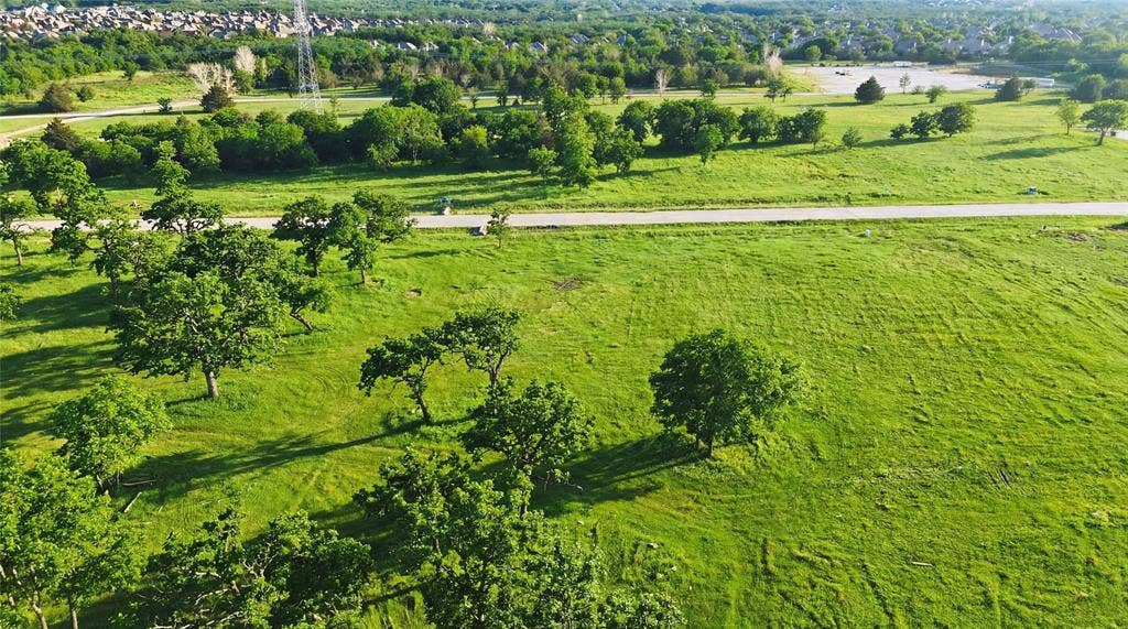 This is an aerial photograph of Lot 8 Block J and was captured in February. It has been digitally enhanced to emphasize the presence of leaves and grass.