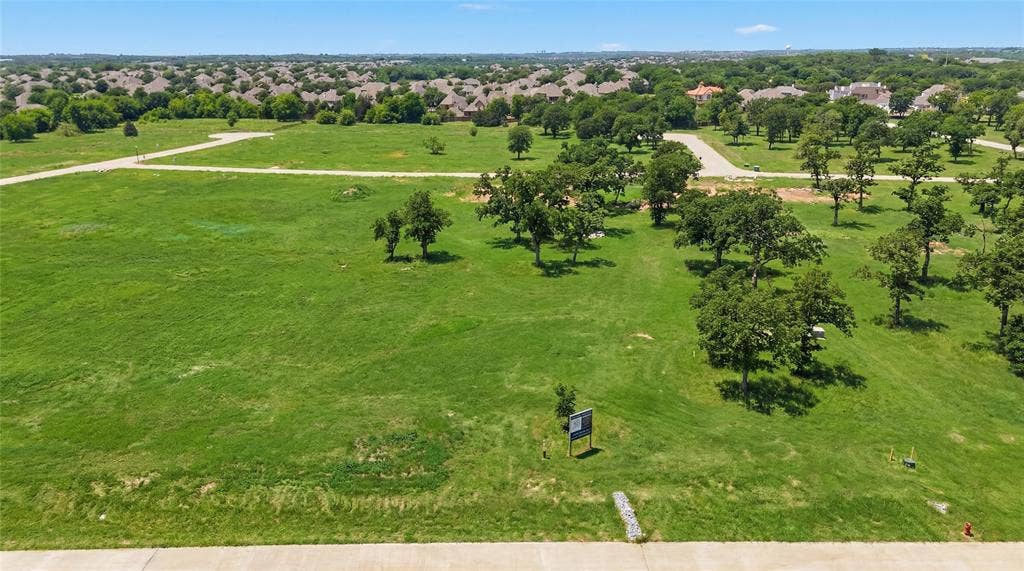 This is an aerial photograph of Lot 8 Block J and was captured in February. It has been digitally enhanced to emphasize the presence of leaves and grass.