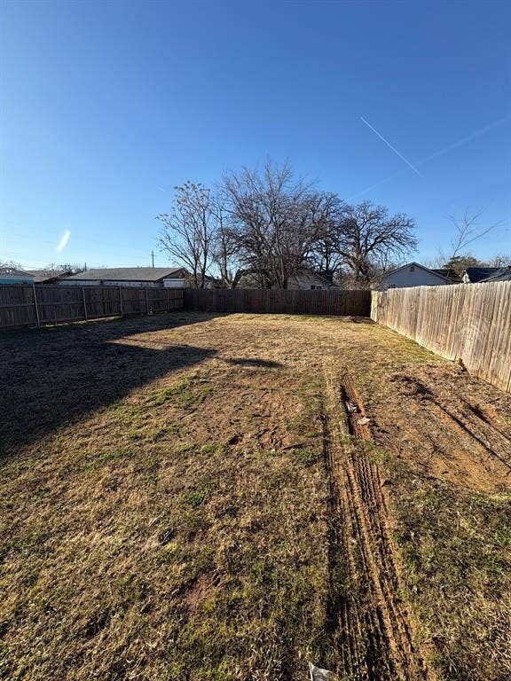 4209 Metropolitan Avenue, Dallas, TX 75210 Backyard with wood fence.