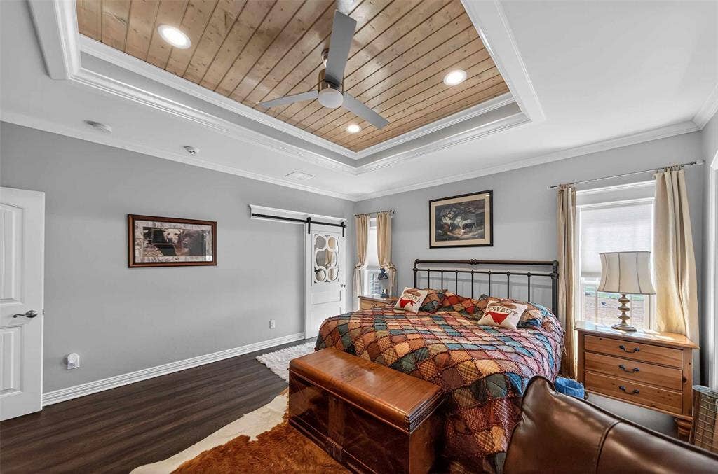 23151 Champion Drive, Lindale, TX 75771 Bedroom featuring a barn door, wood finished floors, a ceiling fan, recessed lighting, and crown molding
