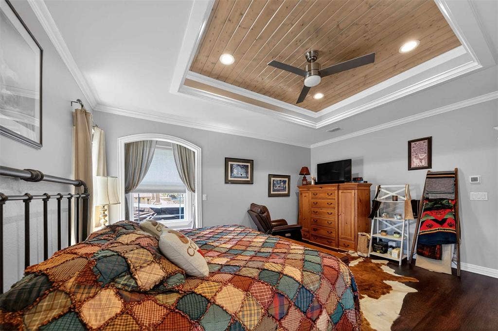 23151 Champion Drive, Lindale, TX 75771 Bedroom featuring wood finished floors, recessed lighting, crown molding, a ceiling fan, and a wooden tray ceiling
