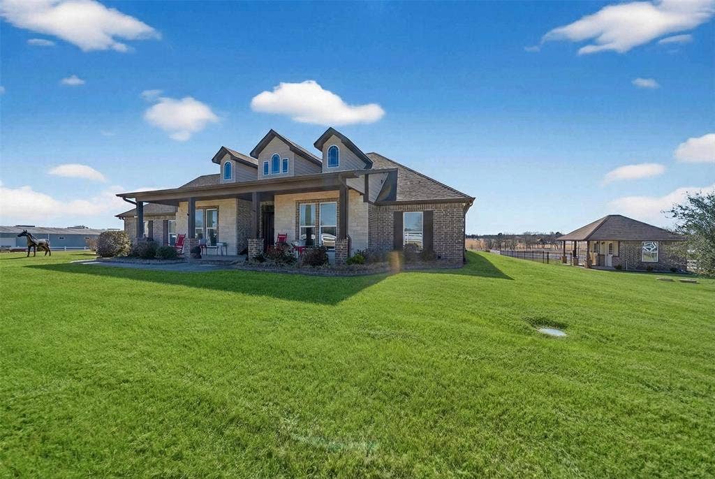 23151 Champion Drive, Lindale, TX 75771 Front of house featuring a yard, covered porch, and brick siding