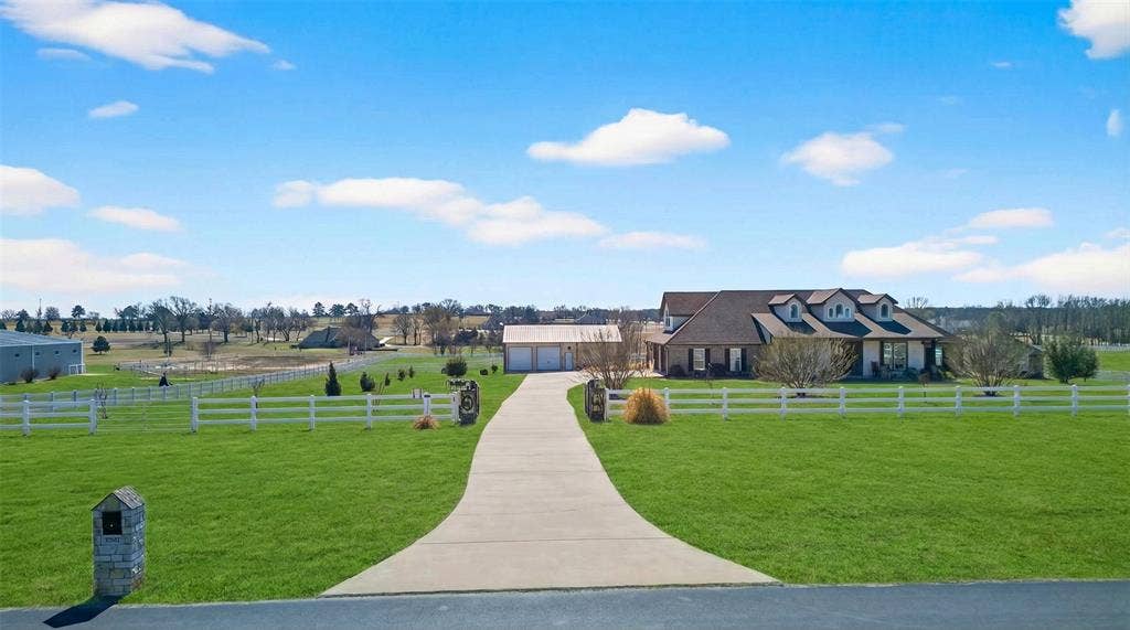 23151 Champion Drive, Lindale, TX 75771 View of home's community featuring driveway, a fenced front yard, and a garage