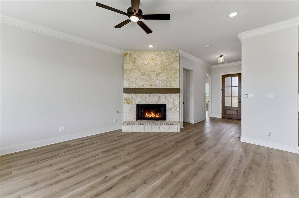 2204 Continent Court, Krum, TX 76249 Living area featuring a stone fireplace with a wood mantel, wood-finish flooring, recessed lighting, and a ceiling fan