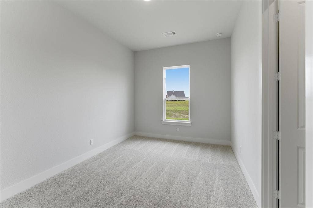 2204 Continent Court, Krum, TX 76249 Carpeted interior room with white walls, baseboards, and ceiling