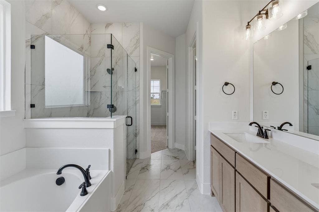 2204 Continent Court, Krum, TX 76249 Bathroom featuring a tile floor, a shower with a clear glass enclosure, a built-in bathtub with a dark-finish faucet, and a double vanity with a light-finish cabinet, white countertops, and dark-finish fixtures