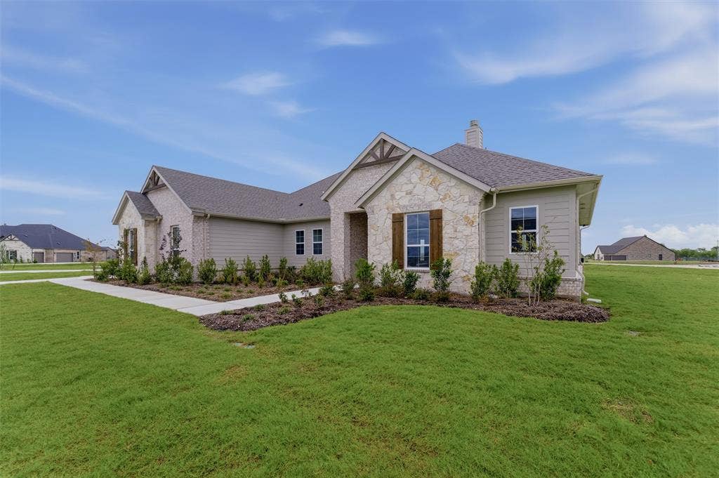 2204 Continent Court, Krum, TX 76249 Contemporary ranch-style exterior featuring a combination of stone veneer and horizontal siding