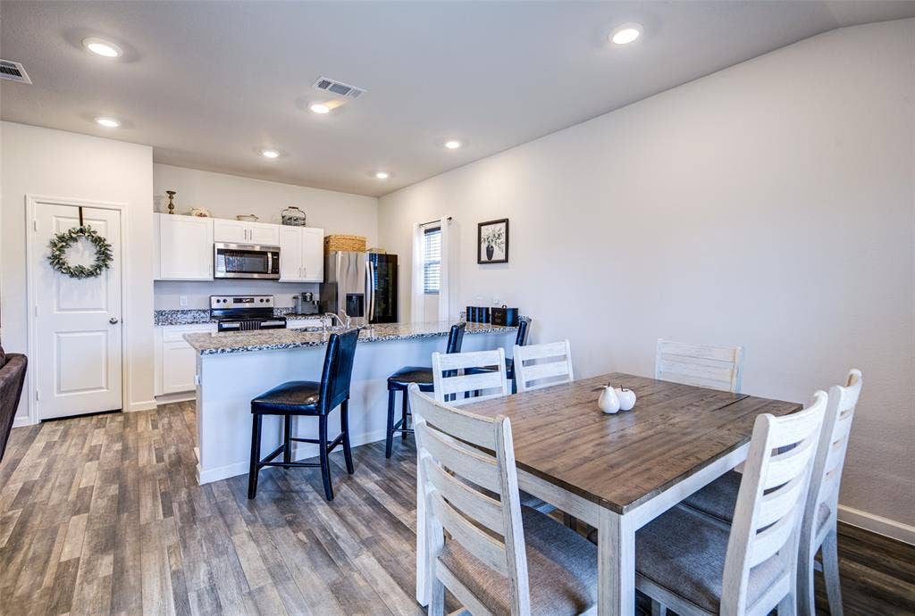 Dining space featuring dark wood finished floors and recessed lighting