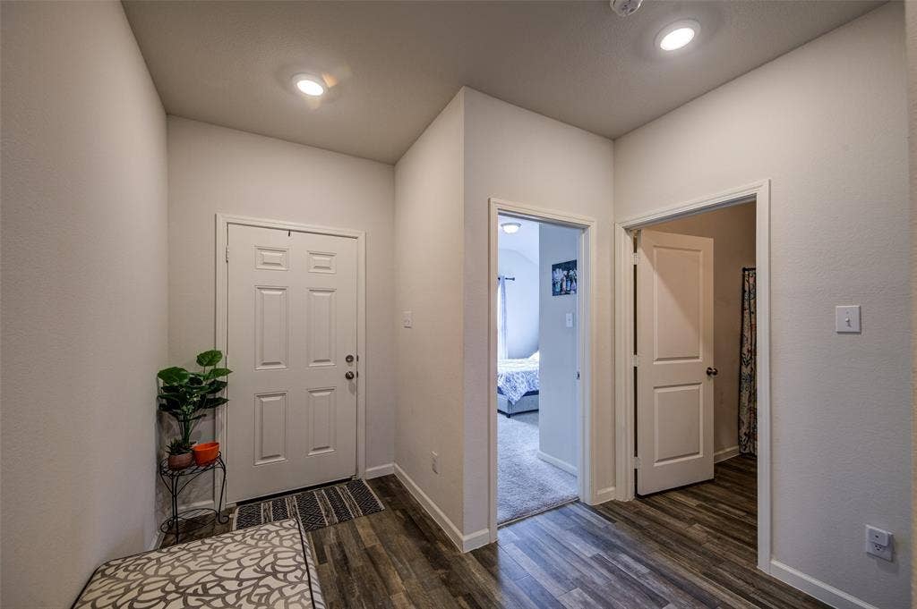 Entrance foyer featuring dark wood-style flooring and recessed lighting