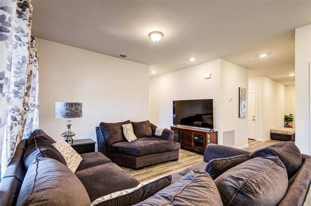 Living room featuring wood finished floors and recessed lighting