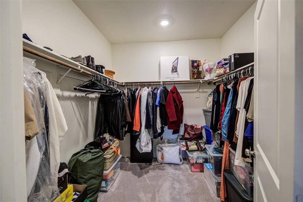 Walk in closet featuring light carpet