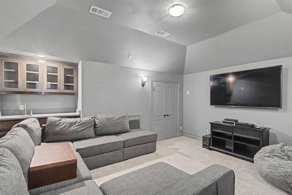 3409 Florence Drive, Corinth, TX 76210 Media Room featuring vaulted ceiling and carpet floors