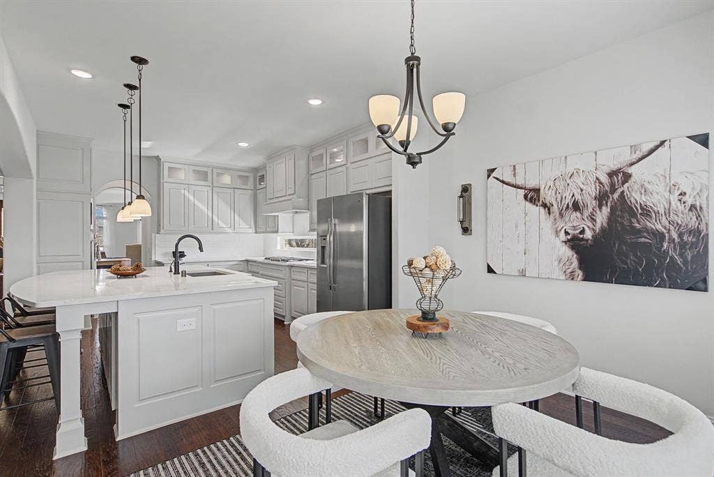 3409 Florence Drive, Corinth, TX 76210 Dining room featuring dark wood-type flooring and suspended lighting