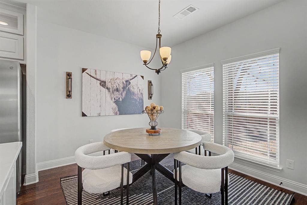 3409 Florence Drive, Corinth, TX 76210 Dining room featuring dark wood-style floors and a chandelier