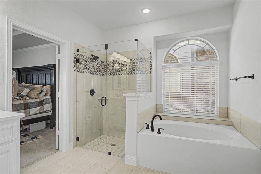 3409 Florence Drive, Corinth, TX 76210 Ensuite bathroom with a stall shower, a bath, and light tile patterned floors